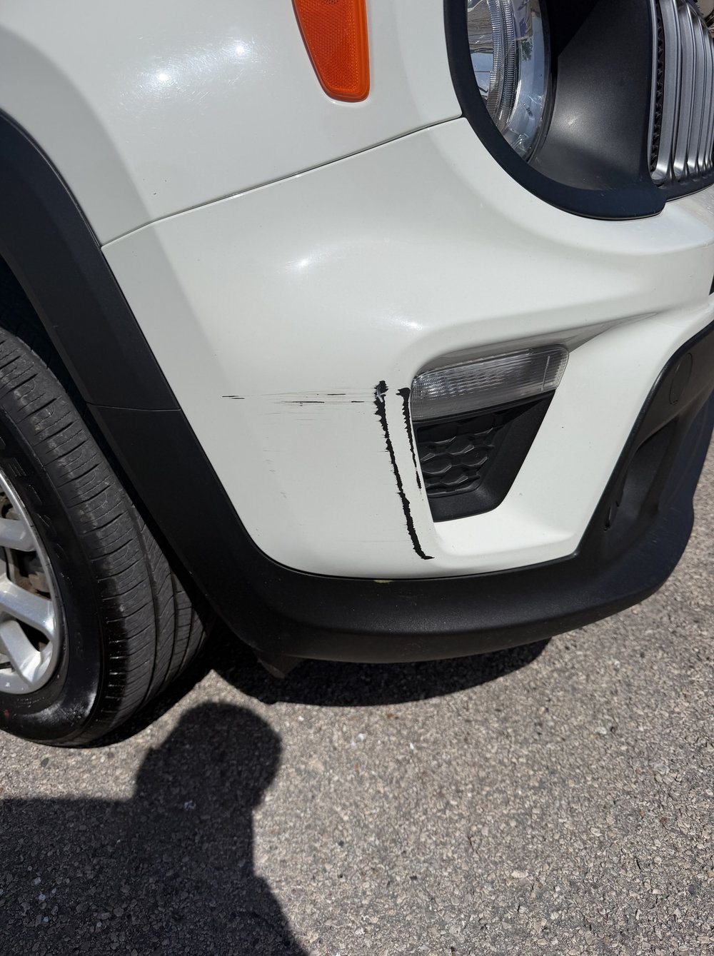 Jeep fender before repair, chips along the edge